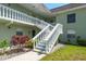 Exterior of building showing stairs leading to upper units with decorative white railing at 1250 S Pinellas Ave # 214, Tarpon Springs, FL 34689