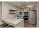 Modern kitchen with granite counters, stainless appliances, and stylish herringbone backsplash at 1250 S Pinellas Ave # 214, Tarpon Springs, FL 34689