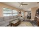 Spacious living room with a sectional sofa, wood floors, and access to the dining area at 1250 S Pinellas Ave # 214, Tarpon Springs, FL 34689