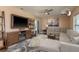 Inviting living room featuring a large sectional sofa, modern fan, and stylish decor at 1250 S Pinellas Ave # 214, Tarpon Springs, FL 34689