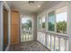 Enclosed sunroom with tiled floor, large windows, and a view of the surrounding trees and neighborhood at 1250 S Pinellas Ave # 214, Tarpon Springs, FL 34689