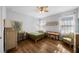 Bright, airy bedroom with wood floors, vintage decor, and natural light streaming through sheer curtains at 12705 Green Heron Way, Odessa, FL 33556