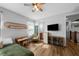 Charming bedroom with light gray walls, wood floors, ceiling fan, and a vintage boho design at 12705 Green Heron Way, Odessa, FL 33556
