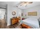 Bedroom with a fan and dresser features hardwood floors and decor at 12705 Green Heron Way, Odessa, FL 33556