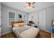 Light filled bedroom with hardwood floors, large windows, and a ceiling fan at 12705 Green Heron Way, Odessa, FL 33556