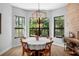 Charming dining area with large windows offering scenic outdoor views and a decorative light fixture at 12705 Green Heron Way, Odessa, FL 33556