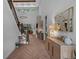 Inviting foyer with herringbone wood floors, stylish console table, and views into the living spaces at 12705 Green Heron Way, Odessa, FL 33556
