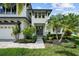 Charming front entrance with stone pathway and lush landscaping, creating a welcoming approach at 12705 Green Heron Way, Odessa, FL 33556