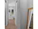 Hallway view of an ensuite bathroom featuring a standalone tub at 12705 Green Heron Way, Odessa, FL 33556