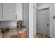 Hallway features light gray cabinets and a countertop with a light gray five panel door at 12705 Green Heron Way, Odessa, FL 33556