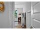 Hallway view of a desk, window, decor, and rug inside a bright room at 12705 Green Heron Way, Odessa, FL 33556