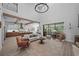 Bright living room with high ceilings, wooden beams, and open floor plan to the kitchen at 12705 Green Heron Way, Odessa, FL 33556