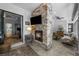 Inviting living room with a stone fireplace, TV, and an open sliding glass door to the lanai at 12705 Green Heron Way, Odessa, FL 33556