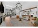Bright living room featuring a grand staircase, fireplace, and open floor plan flowing into a modern kitchen at 12705 Green Heron Way, Odessa, FL 33556