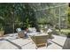 Covered patio area features comfortable seating and neutral stone flooring at 12705 Green Heron Way, Odessa, FL 33556