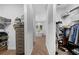 Organized walk-in closet with shelves, hanging rods, and access to ensuite bathroom at 12705 Green Heron Way, Odessa, FL 33556