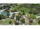 Aerial view showcasing the golf course with community pool, clubhouse, and pond at 13423 Crest Lake Dr, Hudson, FL 34669