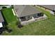 Aerial view of a home's backyard, highlighting its patio, fenced yard, and proximity to neighbors at 13423 Crest Lake Dr, Hudson, FL 34669