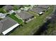 Aerial view showcasing a home's large backyard near a scenic pond and well-maintained landscaping at 13423 Crest Lake Dr, Hudson, FL 34669