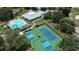 An aerial view features the community amenities, including a pool, tennis, and pickleball courts at 13423 Crest Lake Dr, Hudson, FL 34669