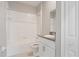 Bathroom featuring a shower-tub combo, single sink vanity with granite counters and modern white cabinets at 13423 Crest Lake Dr, Hudson, FL 34669
