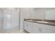 Modern bathroom featuring a glass enclosed shower and double sink vanity at 13423 Crest Lake Dr, Hudson, FL 34669