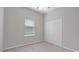 Neutral bedroom featuring carpet, window with blinds, and double door closet at 13423 Crest Lake Dr, Hudson, FL 34669