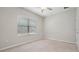 Empty bedroom featuring carpet flooring, ceiling fan, and a window with blinds at 13423 Crest Lake Dr, Hudson, FL 34669