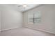 Bright bedroom featuring carpet, window with blinds, and closet at 13423 Crest Lake Dr, Hudson, FL 34669