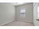 This bedroom features neutral-toned walls, a ceiling fan, carpet, and a bright window with blinds at 13423 Crest Lake Dr, Hudson, FL 34669