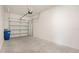 Spacious two-car garage featuring a light colored concrete floor and bright white walls at 13423 Crest Lake Dr, Hudson, FL 34669