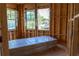 An unfinished bedroom features wood framing, large windows, and construction materials at 1435 17Th N Ave, St Petersburg, FL 33704