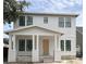 Charming two-story home with white siding, a covered porch, and black-framed windows at 1435 17Th N Ave, St Petersburg, FL 33704