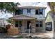 New construction home under construction with gray masonry, a covered entry and black window trim at 1435 17Th N Ave, St Petersburg, FL 33704