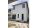New home exterior featuring white siding, black framed windows, and sliding glass doors at 1435 17Th N Ave, St Petersburg, FL 33704