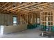 The framed interior of the new home displays the room's layout with visible studs, masonry, and staircase placement at 1435 17Th N Ave, St Petersburg, FL 33704