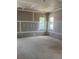 Spacious living room featuring two windows, ample natural light, and unfinished flooring at 1435 17Th N Ave, St Petersburg, FL 33704