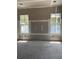 Spacious living room featuring two windows, ample natural light, and unfinished flooring at 1435 17Th N Ave, St Petersburg, FL 33704