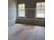 Spacious living room featuring two windows, ample natural light, and unfinished flooring at 1435 17Th N Ave, St Petersburg, FL 33704