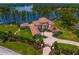Impressive aerial view of an elegant estate with well-manicured grounds, mature trees, and lakefront access at 17124 Crawley Rd, Odessa, FL 33556