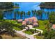 Stunning aerial view of a sprawling estate with a terracotta roof, lush landscaping, and a circular driveway at 17124 Crawley Rd, Odessa, FL 33556