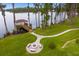 The backyard offers a waterside fire pit and walkway to a covered boat dock at 17124 Crawley Rd, Odessa, FL 33556