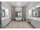 This spa-like bathroom features double sinks, mosaic tile accents, and a freestanding tub under a chandelier at 17124 Crawley Rd, Odessa, FL 33556