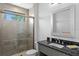 Modern bathroom featuring a tiled shower with glass door and granite vanity at 17124 Crawley Rd, Odessa, FL 33556