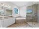 Bright bathroom featuring tiled floors, double sinks, bathtub and glass shower at 17124 Crawley Rd, Odessa, FL 33556