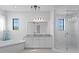 Bright bathroom with double sinks, shower and a separate soaking tub at 17124 Crawley Rd, Odessa, FL 33556