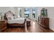 Main bedroom features hardwood floors, large windows, and lake views at 17124 Crawley Rd, Odessa, FL 33556