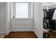 Well-organized closet area with drawers, shelves, and a small window, offering practical storage solutions at 17124 Crawley Rd, Odessa, FL 33556