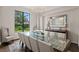 Formal dining room with elegant chandelier, large window, and seating for ten offers a sophisticated ambiance at 17124 Crawley Rd, Odessa, FL 33556