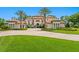 Stunning Mediterranean-style home with a tile roof, lush landscaping, and a circular driveway at 17124 Crawley Rd, Odessa, FL 33556